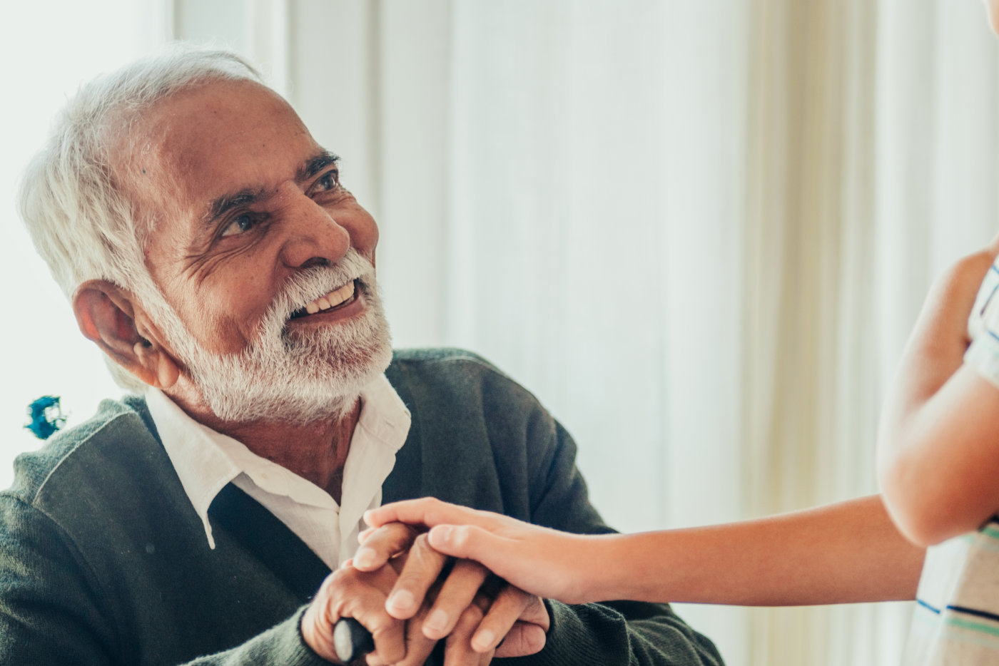 Elderly Indian man talking with a young boy.