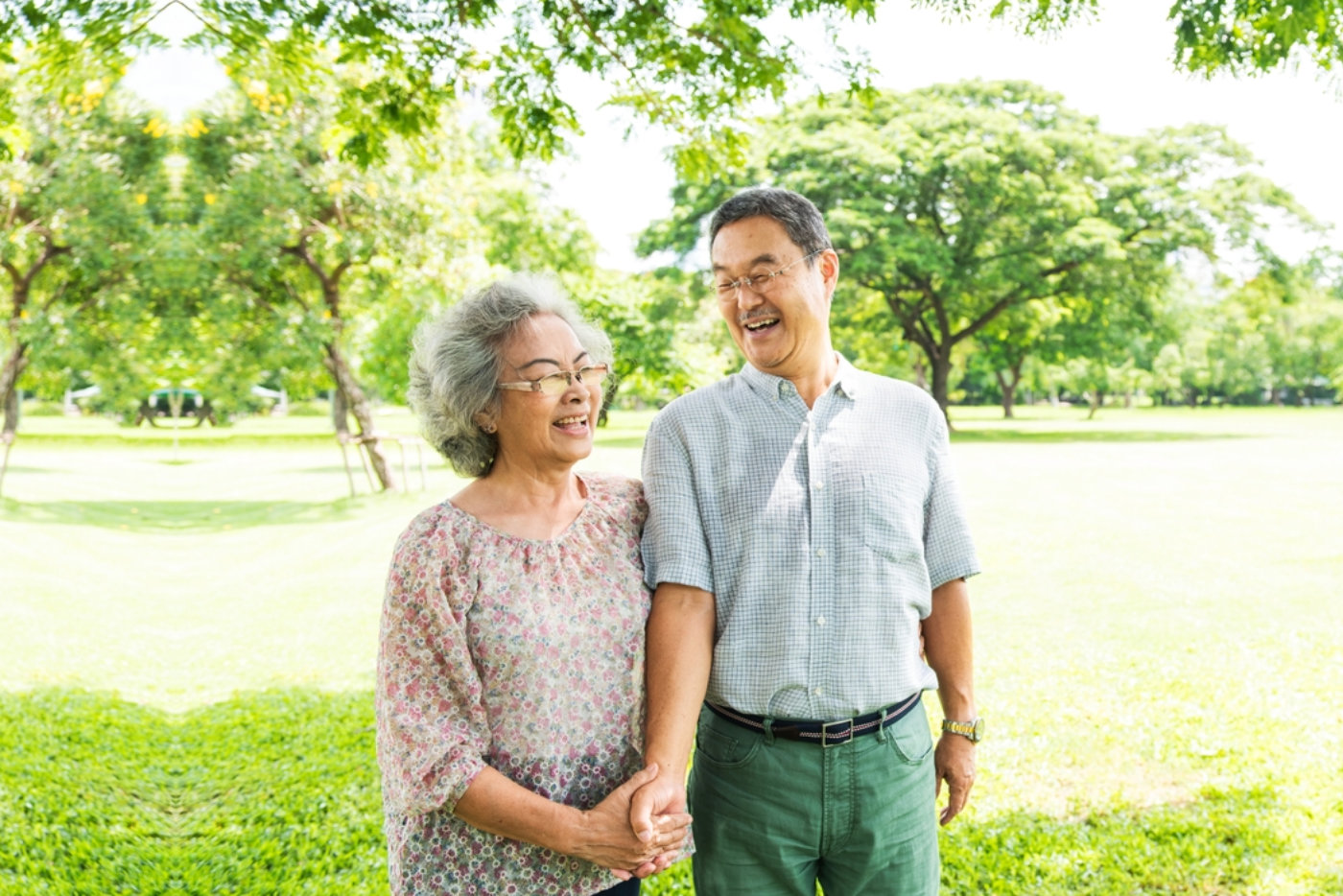 Elderly walking in a sunny park